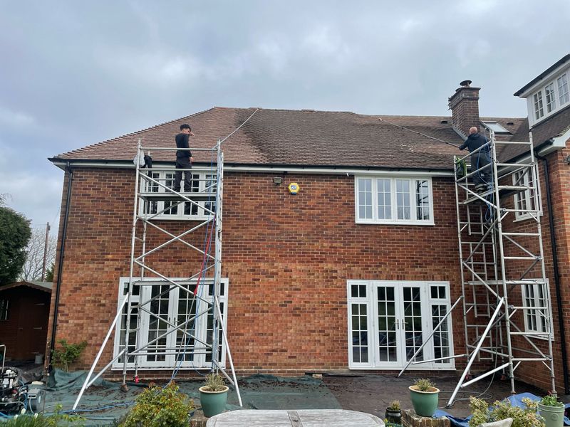 Roof cleaning carried out safely from scaffold towers by The Roof Moss Cleaners in Oaklands